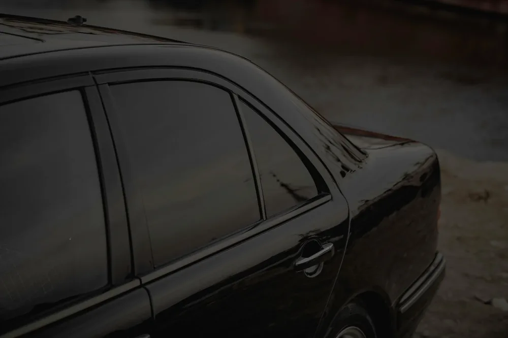 A black car with dark tinted windows