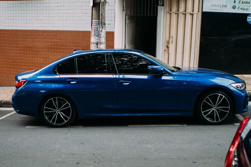 A blue sedan with tinted rear windows
