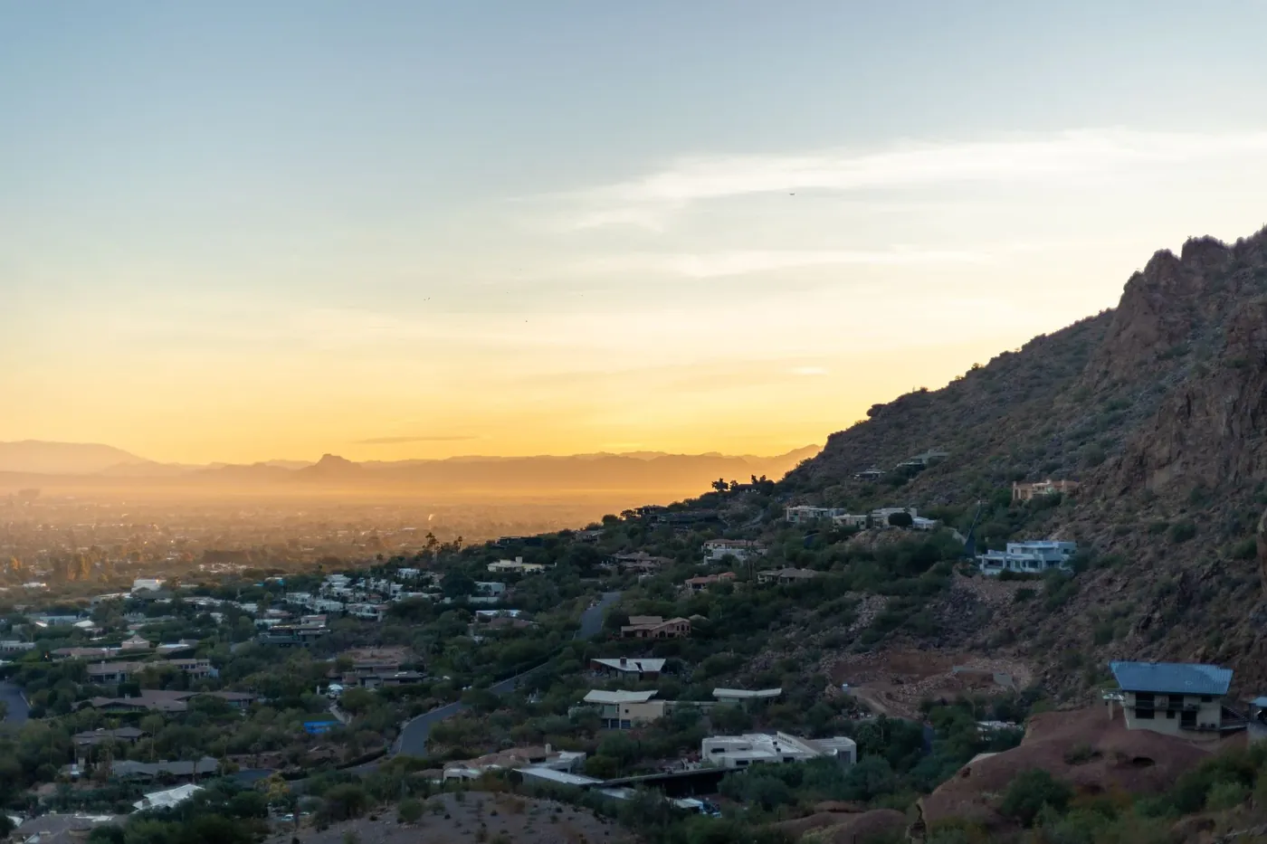 Homes on a hillside above Phoenix at dusk