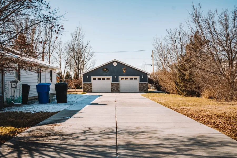 A long new driveway with a drainage channel