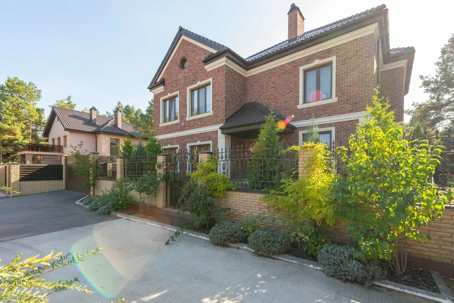 A brick house with a block paved driveway