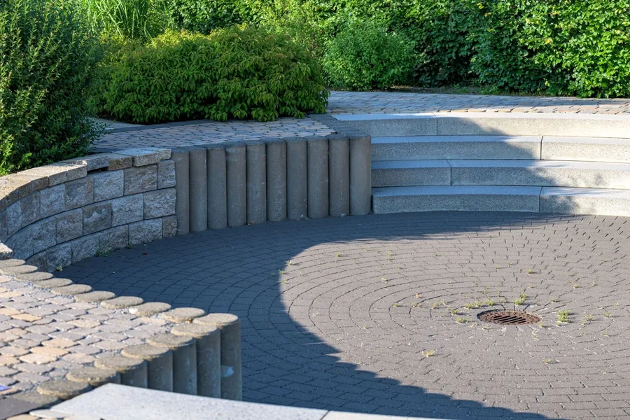 A curved patio with stone steps