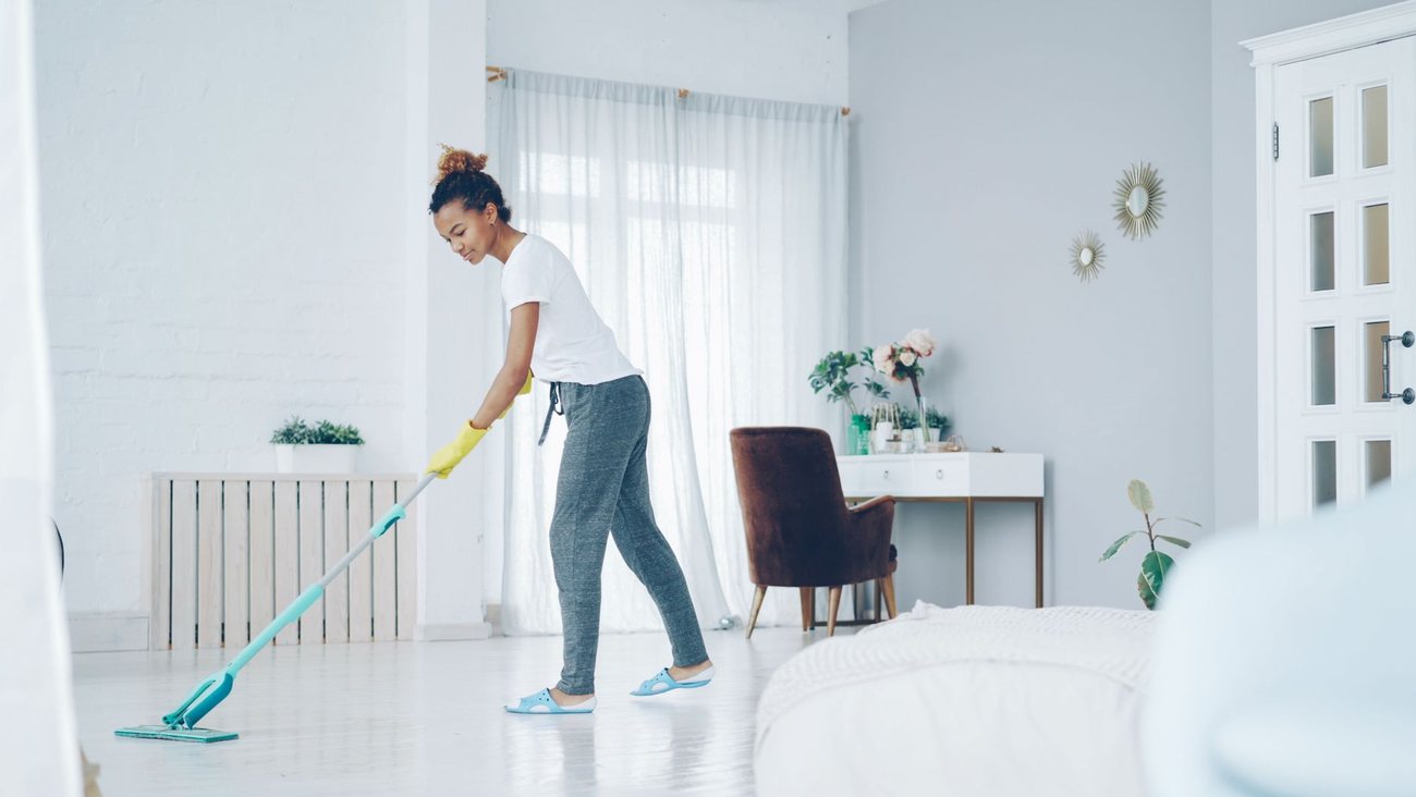 A bright living room being mopped