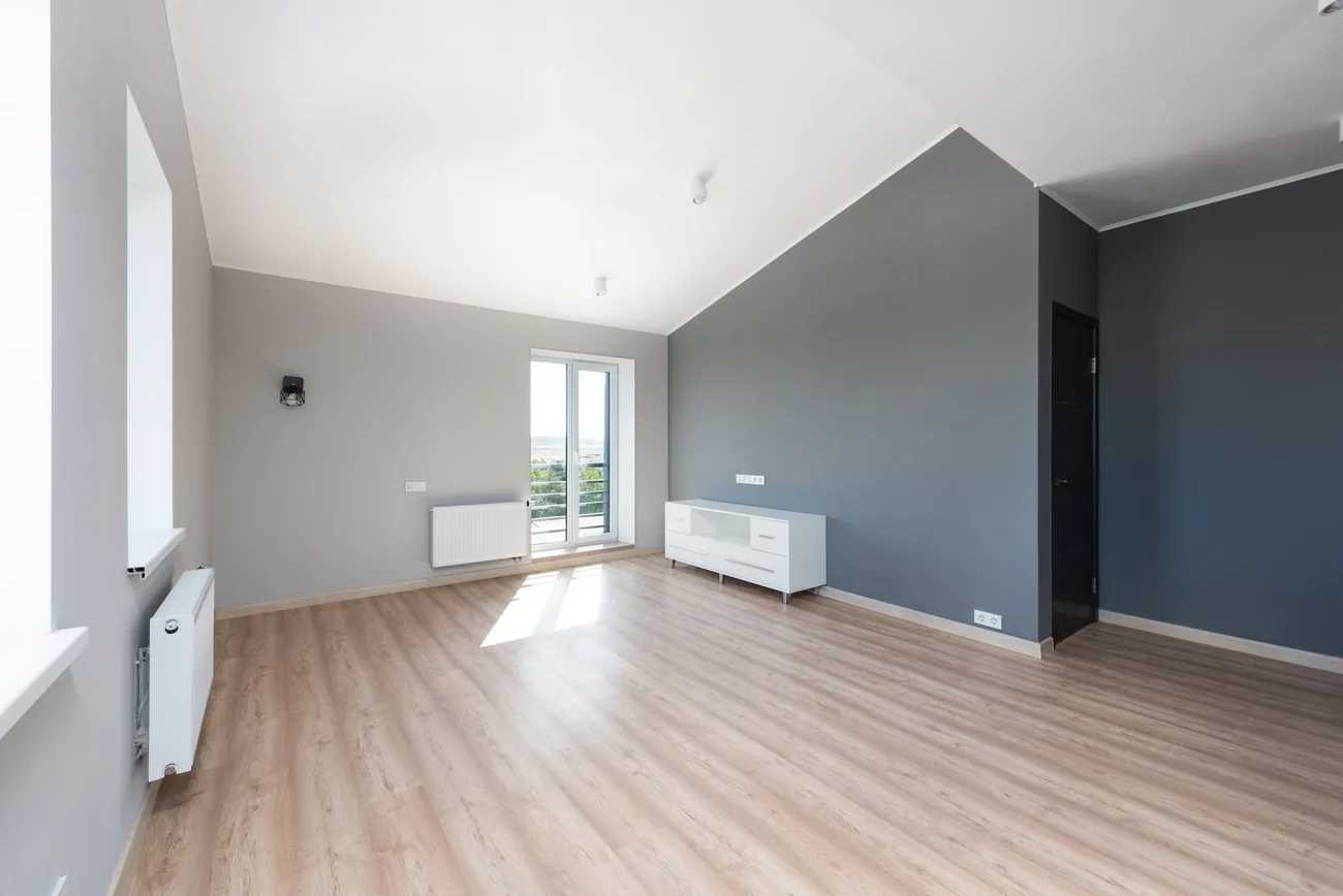 A finished room with light raking across a flat wall