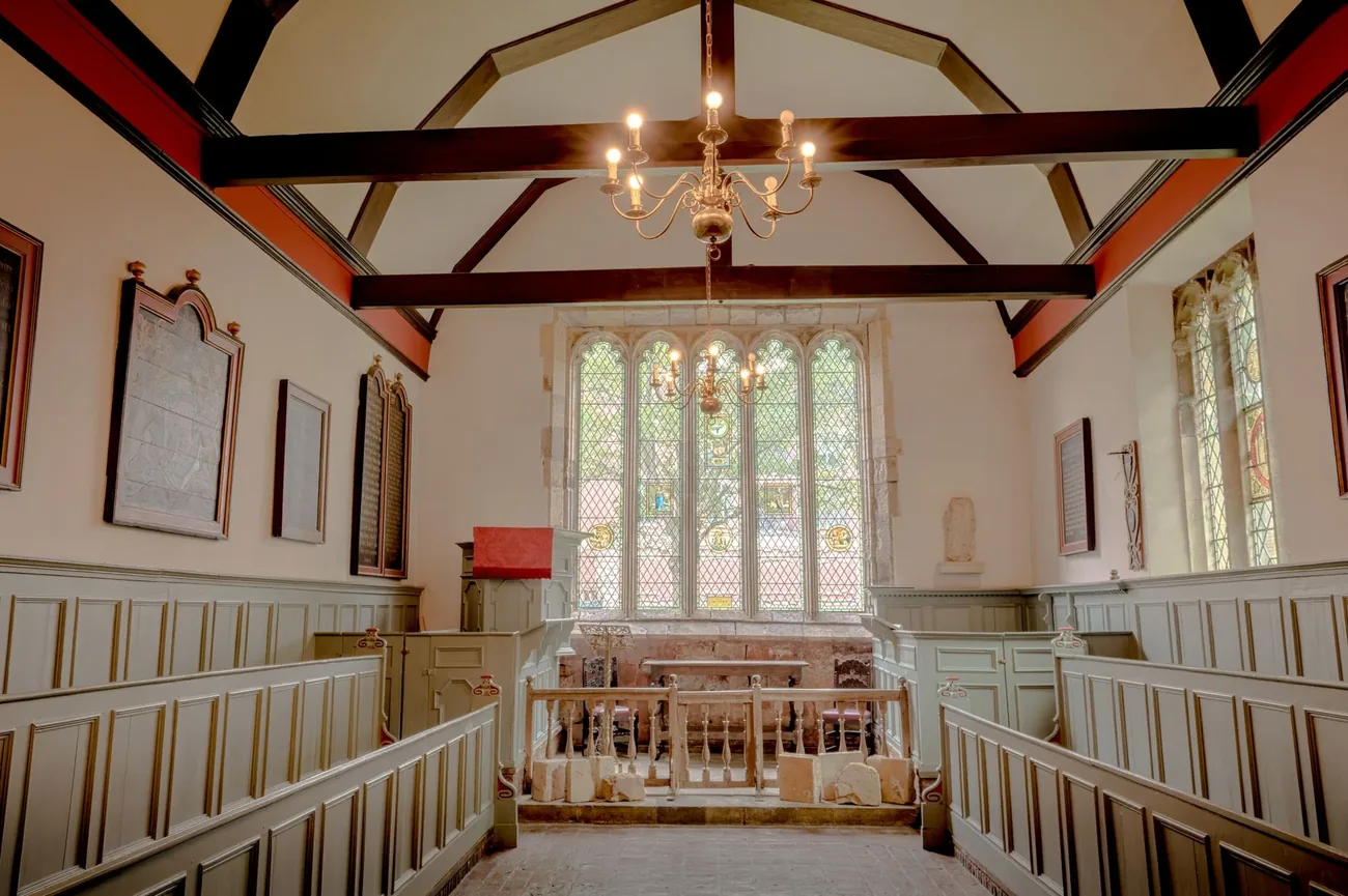 Our chapel, with wooden pews and light through a tall window